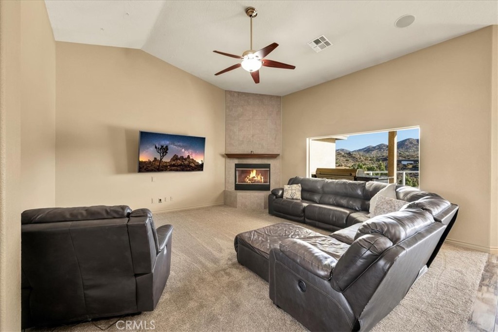 7959 Stephenson Lane Yucca Valley, CA 92284 - Photo 17 of 75 a living room with furniture and a flat screen tv