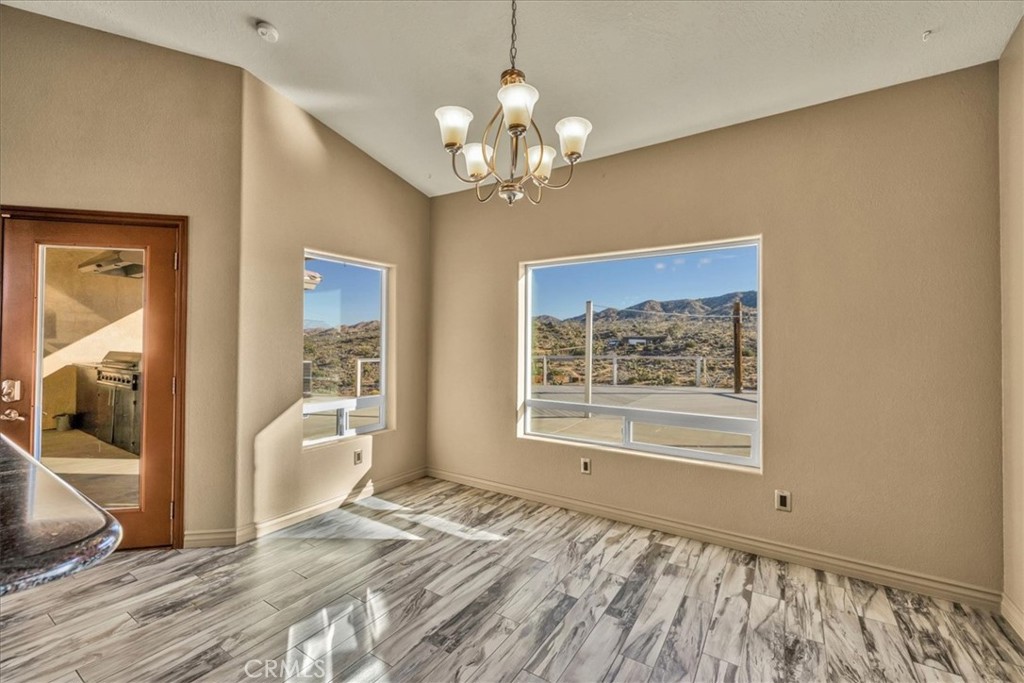 7959 Stephenson Lane Yucca Valley, CA 92284 - Photo 26 of 75 a view of a bedroom with wooden floor and a bedroom