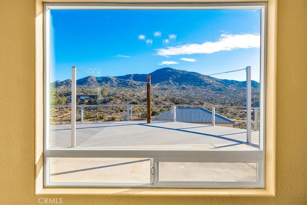 7959 Stephenson Lane Yucca Valley, CA 92284 - Photo 27 of 75 a view of a glass door with a tv