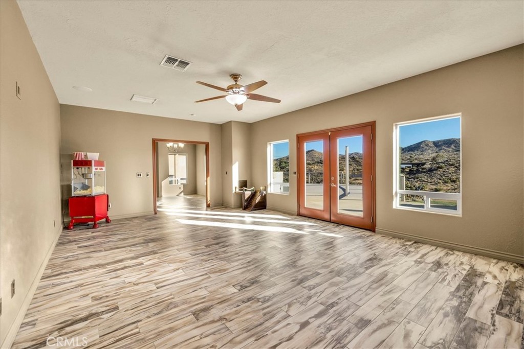 7959 Stephenson Lane Yucca Valley, CA 92284 - Photo 29 of 75 a view of an empty room with window and wooden floor