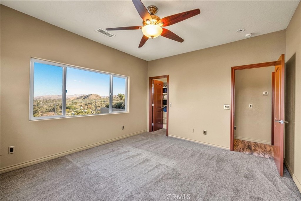 7959 Stephenson Lane Yucca Valley, CA 92284 - Photo 47 of 75 a view of an empty room with window and cabinet