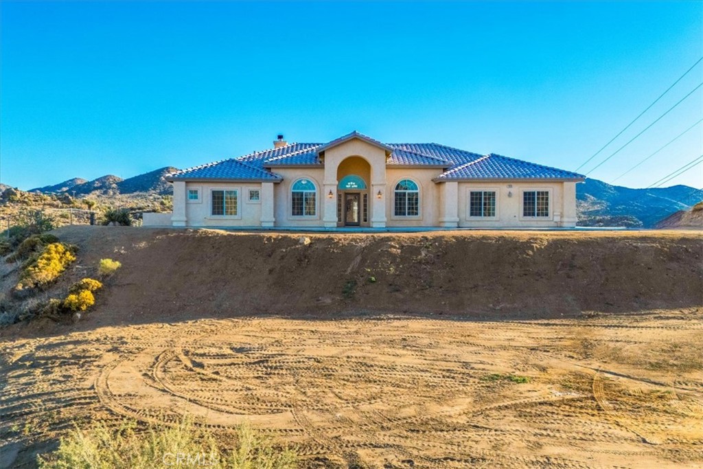 7959 Stephenson Lane Yucca Valley, CA 92284 - Photo 6 of 75 a front view of a house with a yard