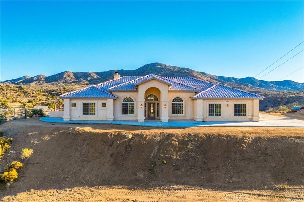 7959 Stephenson Lane Yucca Valley, CA 92284 - Photo 7 of 75 a front view of a house with yard