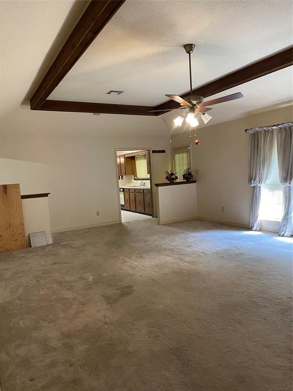 122 Post Oak Drive Mansfield, LA 71052 - Photo 13 of 23 Unfurnished living room featuring a textured ceiling, light colored carpet, and a ceiling fan