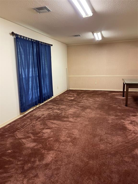 122 Post Oak Drive Mansfield, LA 71052 - Photo 15 of 23 Spare room featuring a textured ceiling and dark carpet