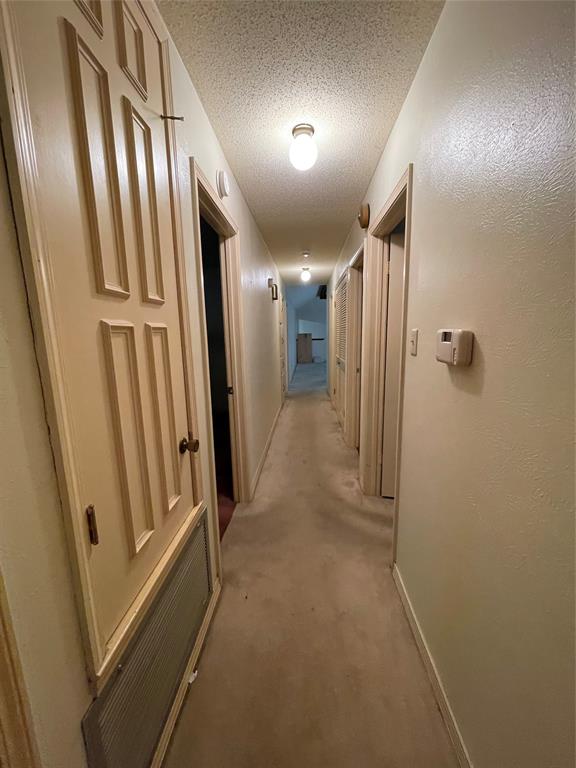 122 Post Oak Drive Mansfield, LA 71052 - Photo 16 of 23 Hall with carpet flooring and a textured ceiling