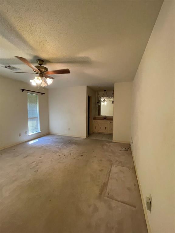 122 Post Oak Drive Mansfield, LA 71052 - Photo 17 of 23 Unfurnished bedroom with carpet, a textured ceiling, and a ceiling fan