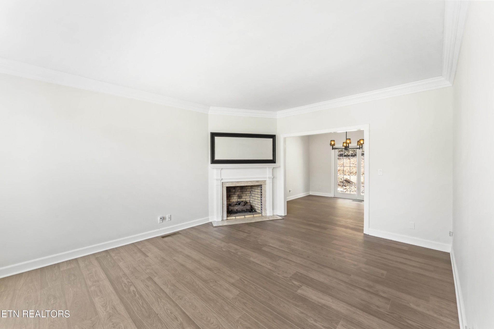 103 Amanda Place Oak Ridge, TN 37830 - Photo 13 of 38 a view of an empty room with wooden floor fireplace and a window