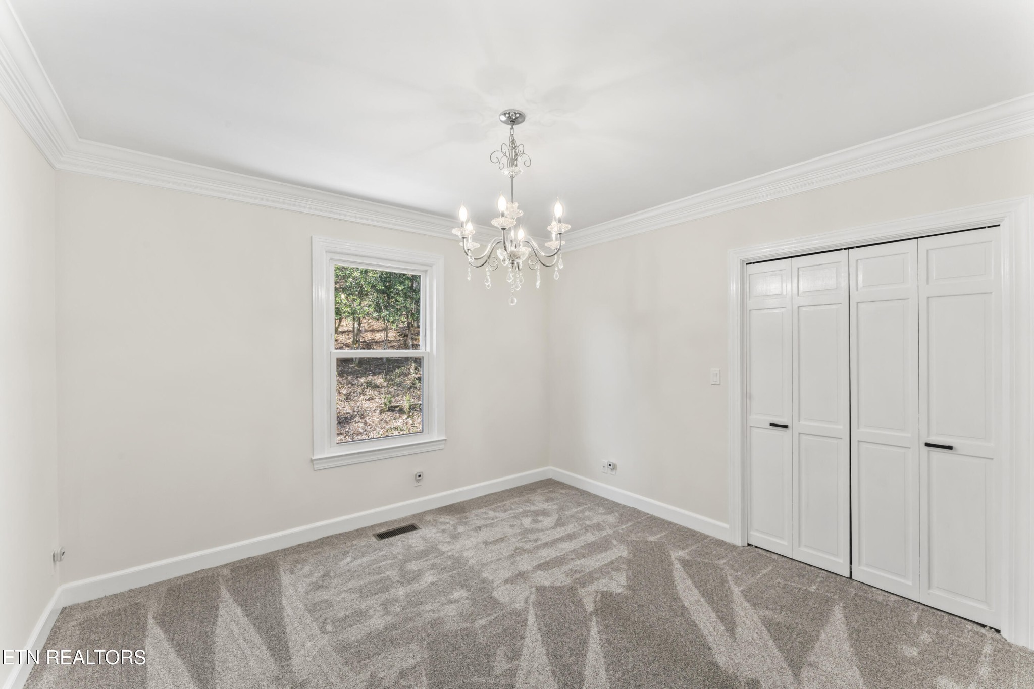 103 Amanda Place Oak Ridge, TN 37830 - Photo 30 of 38 a view of an empty room with window and chandelier fan