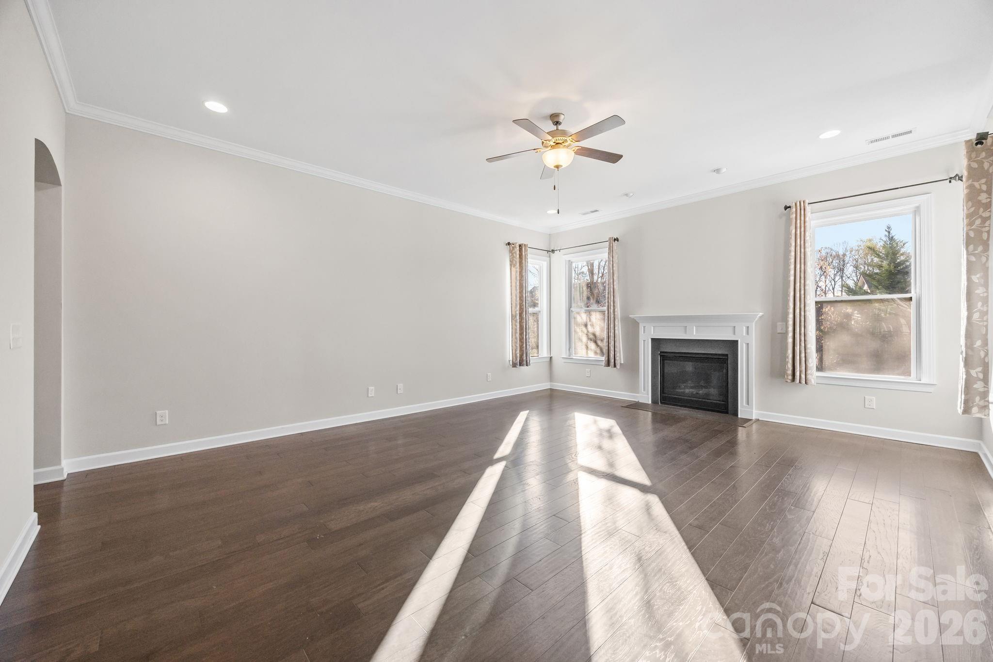 1221 Violet Court Fort Mill, SC 29708 - Photo 11 of 48 an empty room with wooden floor fireplace and windows