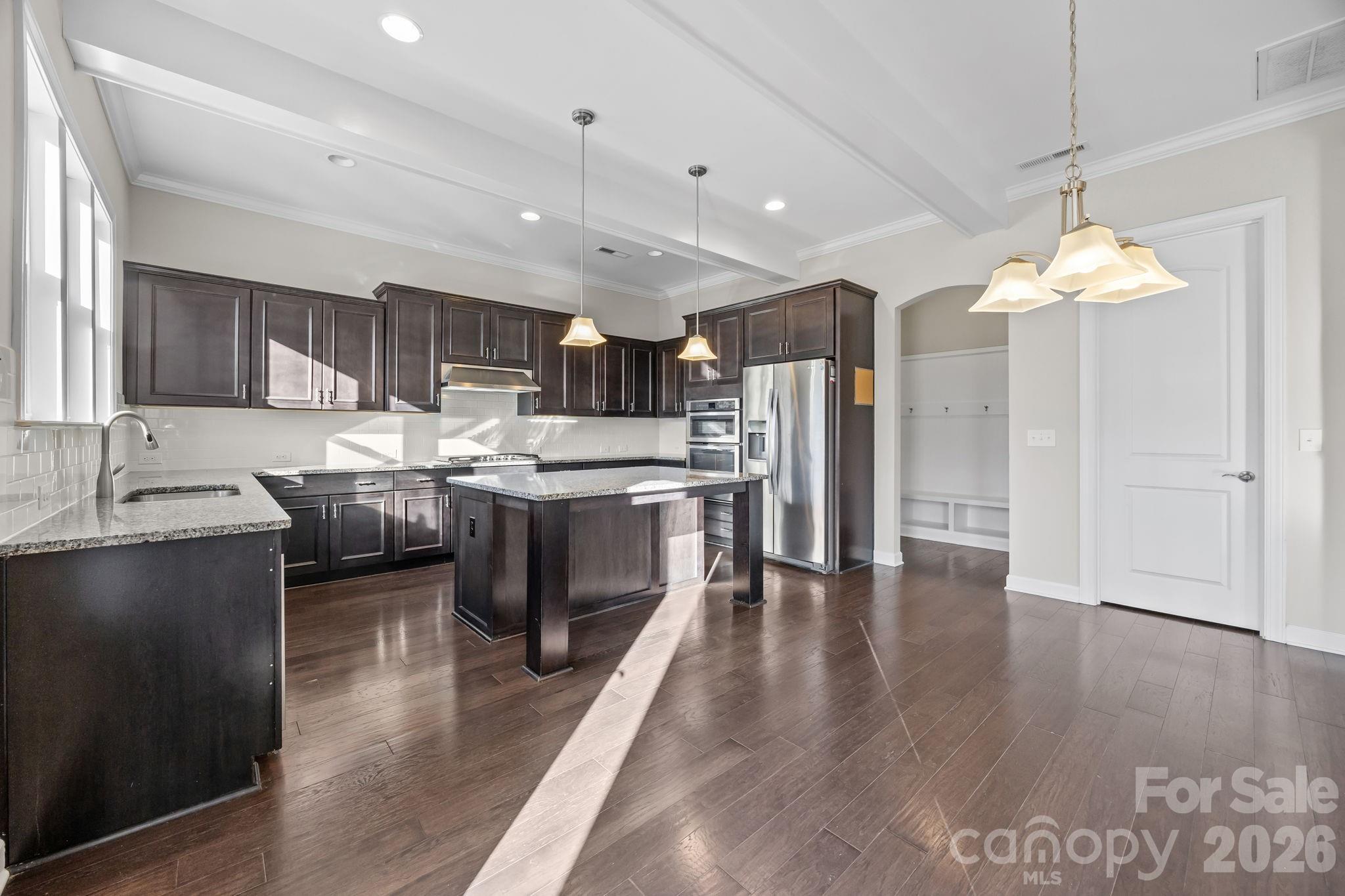 1221 Violet Court Fort Mill, SC 29708 - Photo 15 of 48 a kitchen with stainless steel appliances granite countertop a sink a stove a refrigerator cabinets and wooden floor