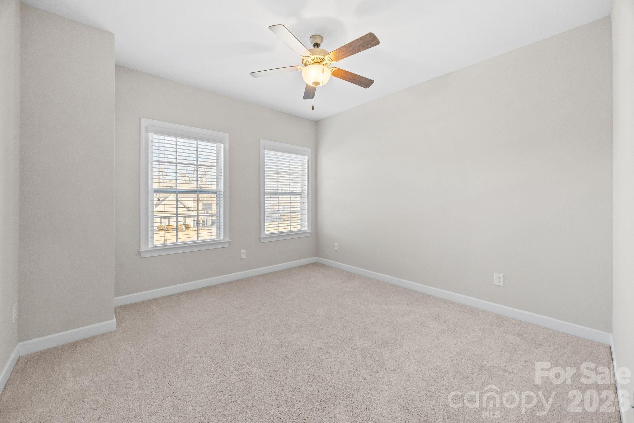 1221 Violet Court Fort Mill, SC 29708 - Photo 25 of 48 an empty room with windows and chandelier fan