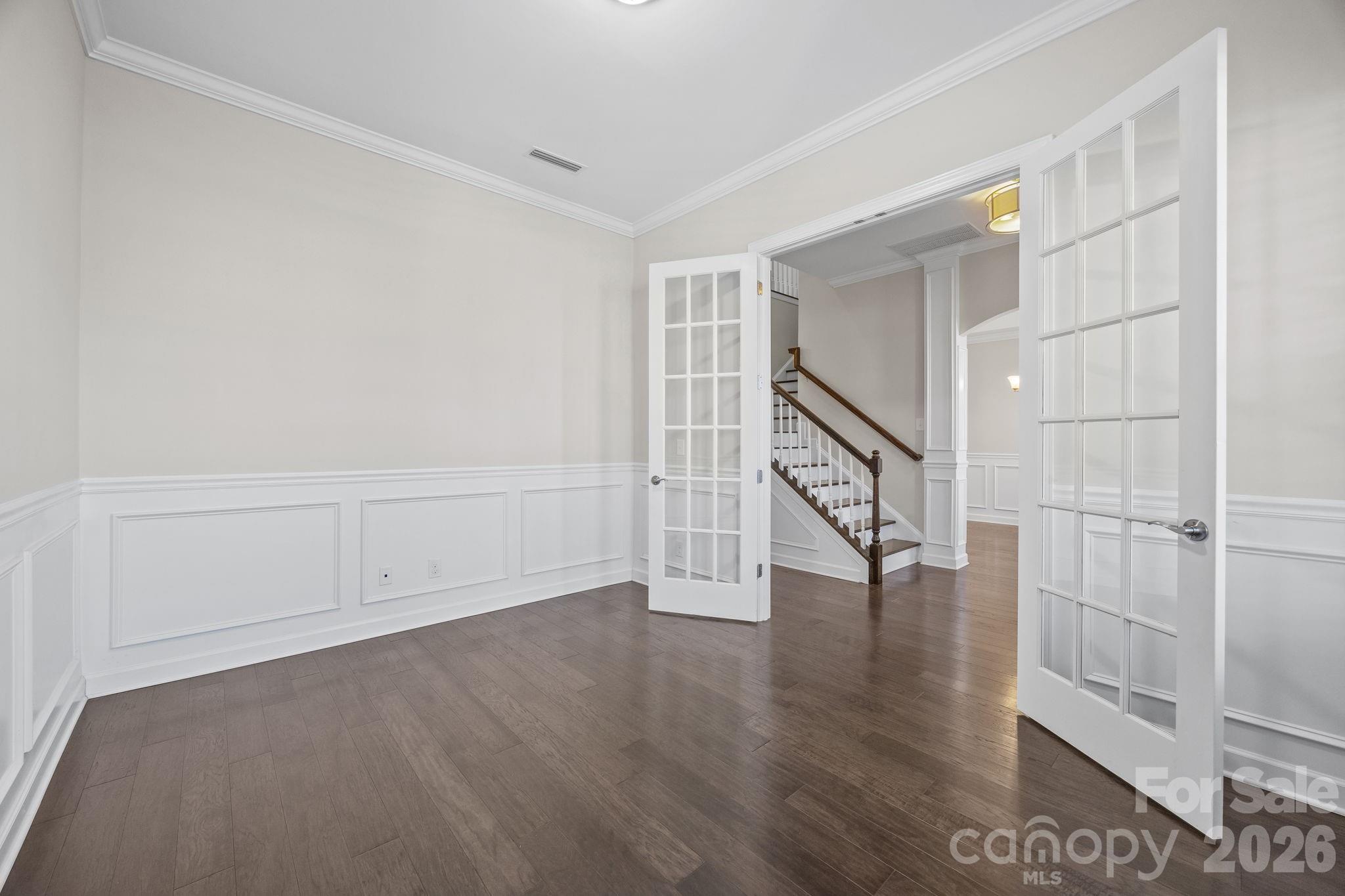 1221 Violet Court Fort Mill, SC 29708 - Photo 6 of 48 a view of an empty room with wooden floor and stairs