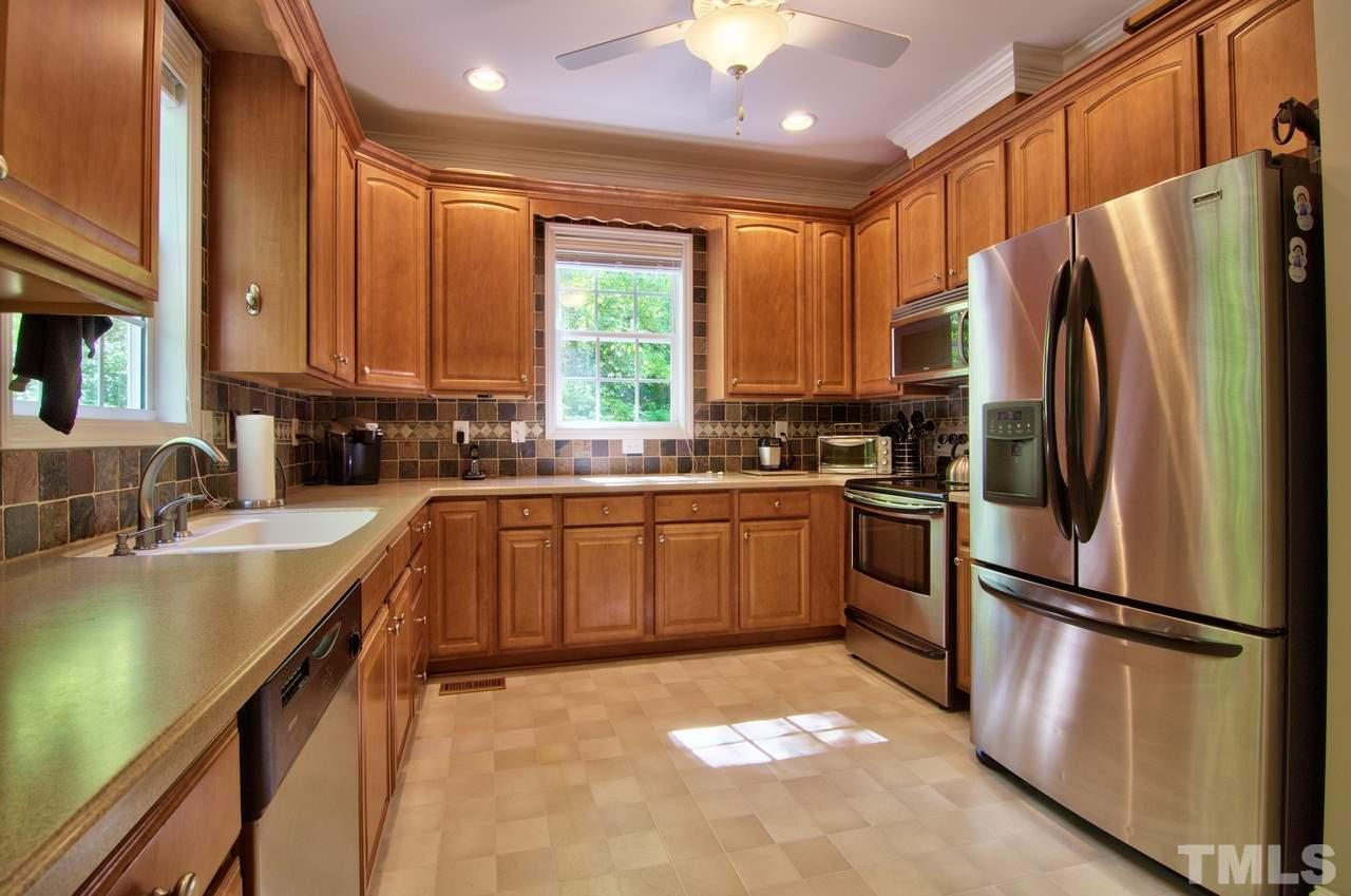28 Finish Line Road Bahama, NC 27503 - Photo 2 of 25 a kitchen with a refrigerator a sink dishwasher a stove and a refrigerator