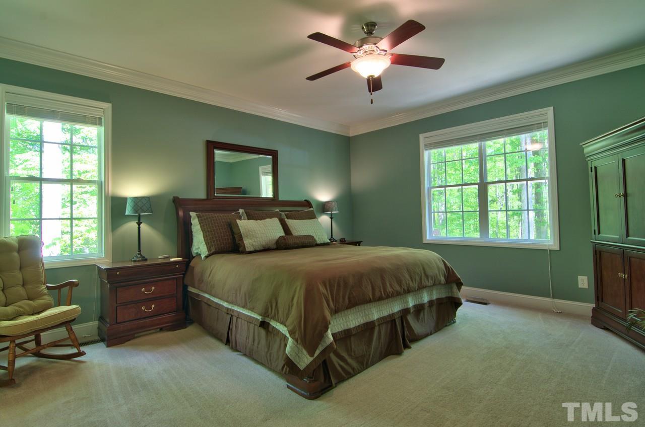 28 Finish Line Road Bahama, NC 27503 - Photo 13 of 25 a bed sitting in a bedroom next to a window