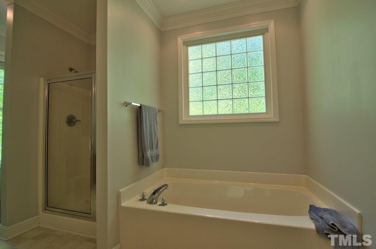 28 Finish Line Road Bahama, NC 27503 - Photo 15 of 25 a white bath tub sitting next to a window