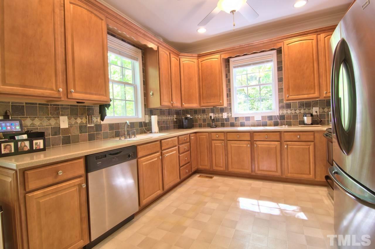 28 Finish Line Road Bahama, NC 27503 - Photo 20 of 25 a kitchen with a sink window and cabinets