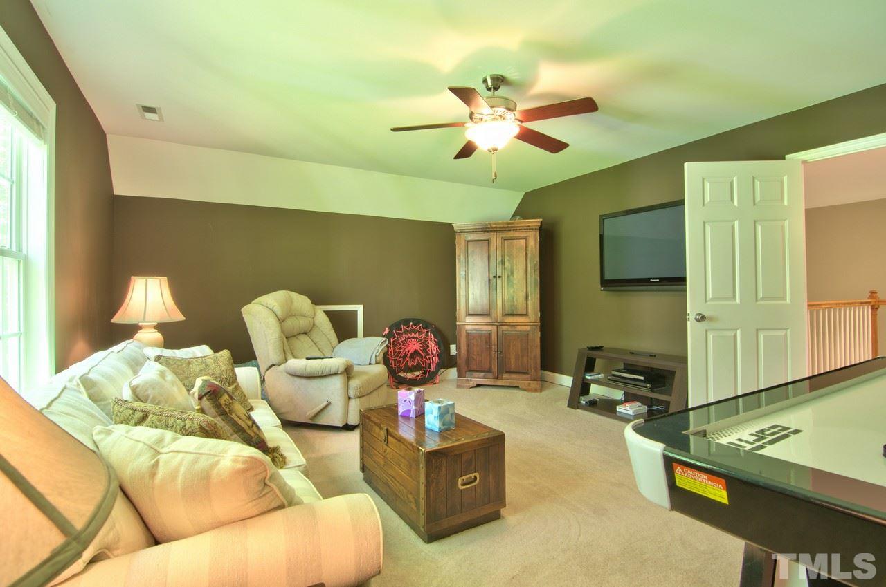 28 Finish Line Road Bahama, NC 27503 - Photo 25 of 25 a room with furniture and a flat screen tv