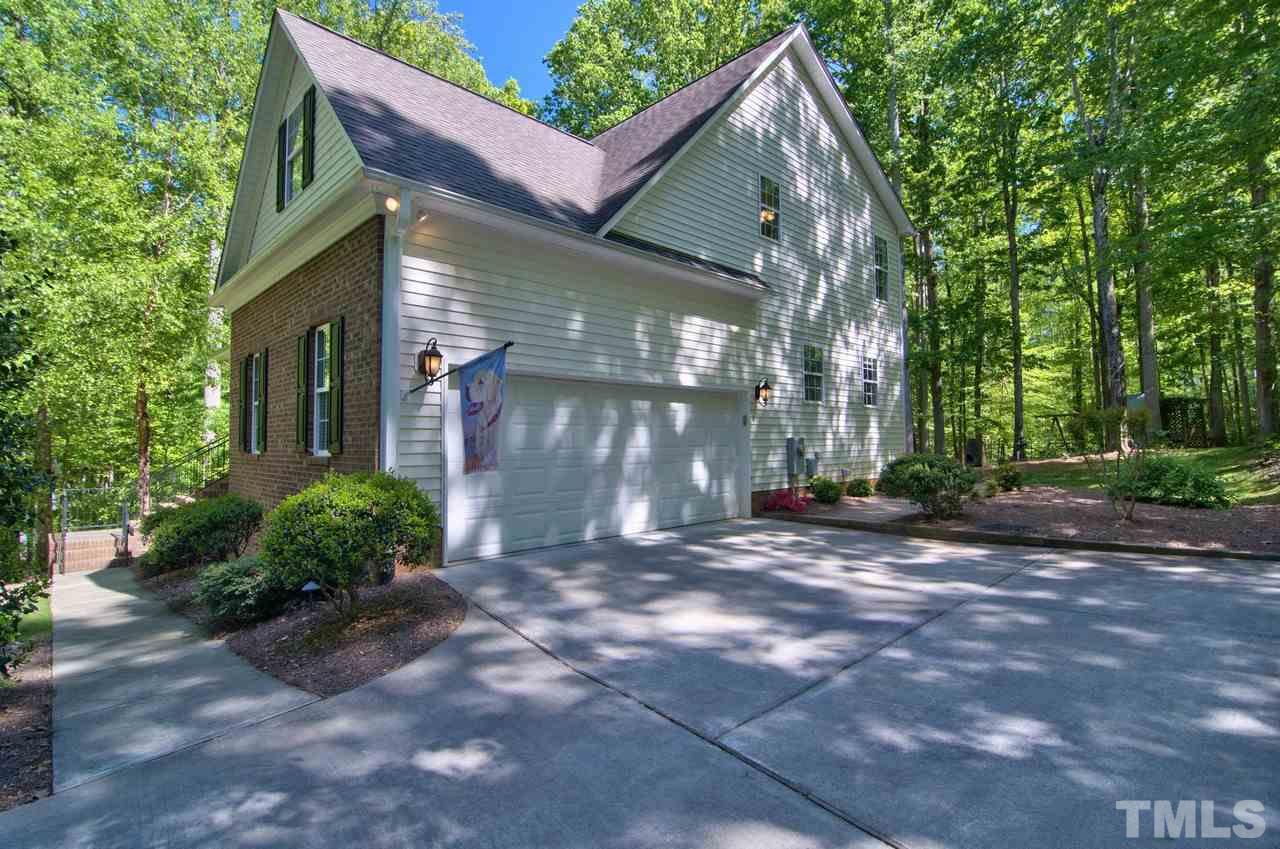 28 Finish Line Road Bahama, NC 27503 - Photo 5 of 25 a view of a house with brick walls and a yard with plants