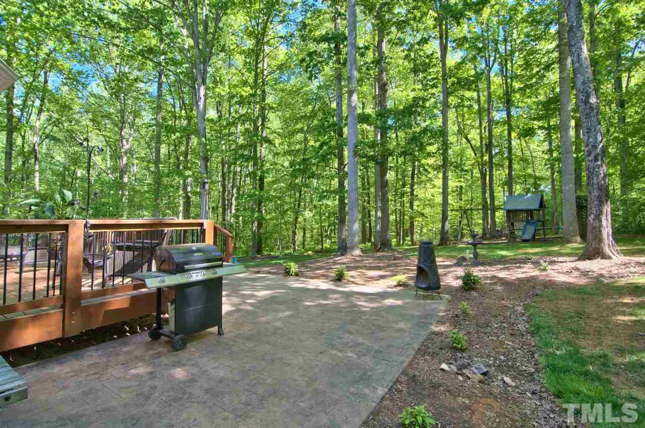 28 Finish Line Road Bahama, NC 27503 - Photo 6 of 25 a backyard of a house with barbeque oven table and chairs