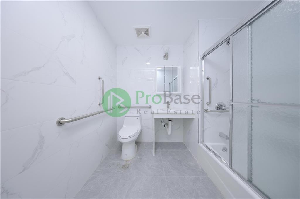 2837 West 19th Street, Unit 2A Brooklyn, NY 11224 - Photo 15 of 19 a bathroom with a sink a toilet and shower