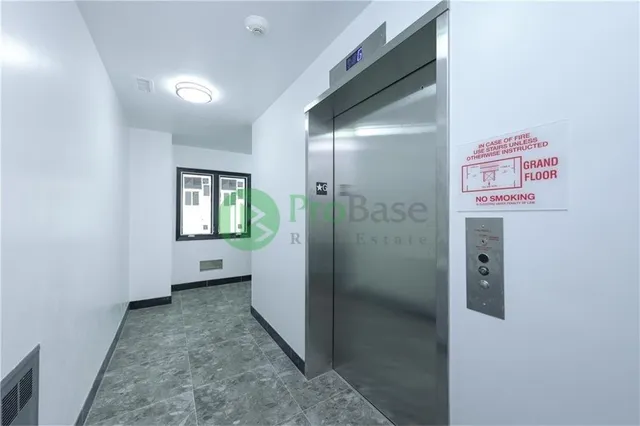 a view of a room with wooden floor and window