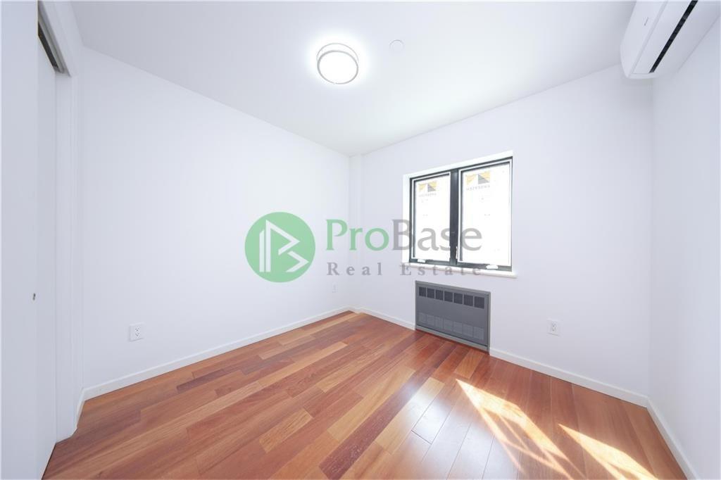 2837 West 19th Street, Unit 2A Brooklyn, NY 11224 - Photo 5 of 19 a view of a room with wooden floor and window
