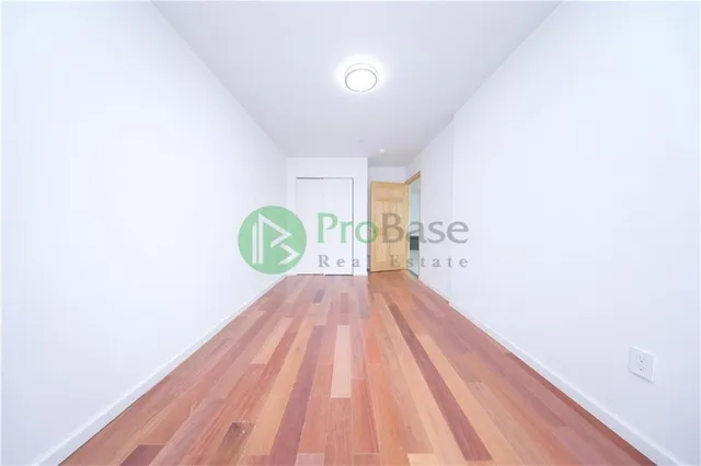 a view of a room with wooden floor and window