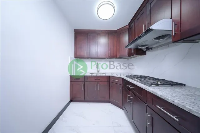 a view of a kitchen with a sink cabinets and entryway