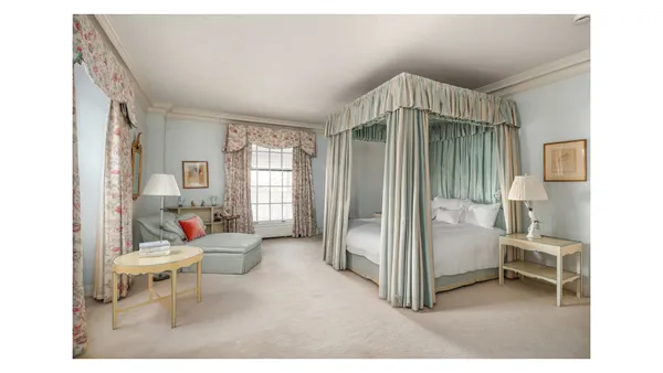 a balcony with chairs and with potted plants