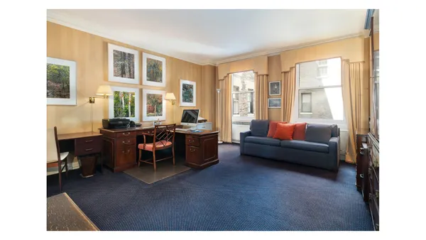 a bedroom with furniture and a large window