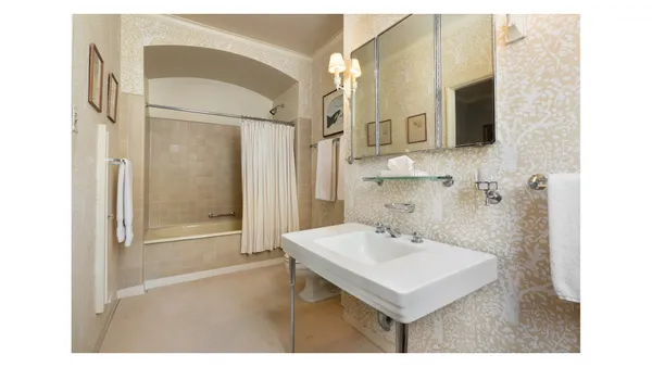 a bedroom with a bed a couch and a window