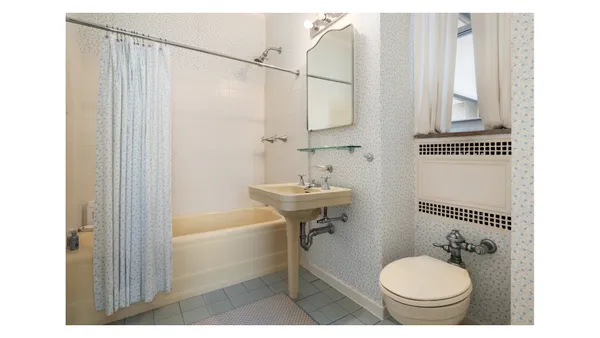 a bathroom with a sink mirror and a shower