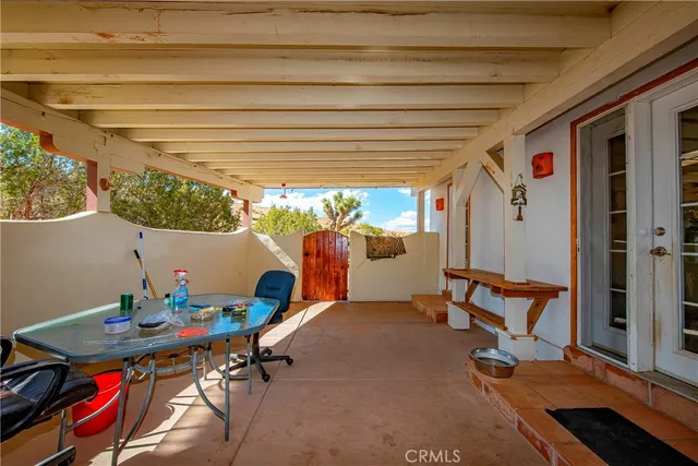 a view of a house with a yard and potted plants