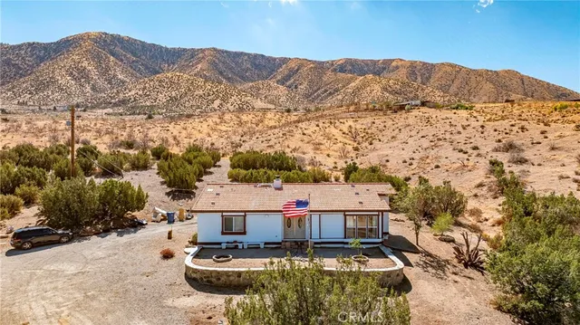 a view of a lake with table and chairs