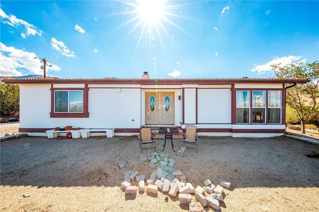 a view of a house with backyard sitting area and garden