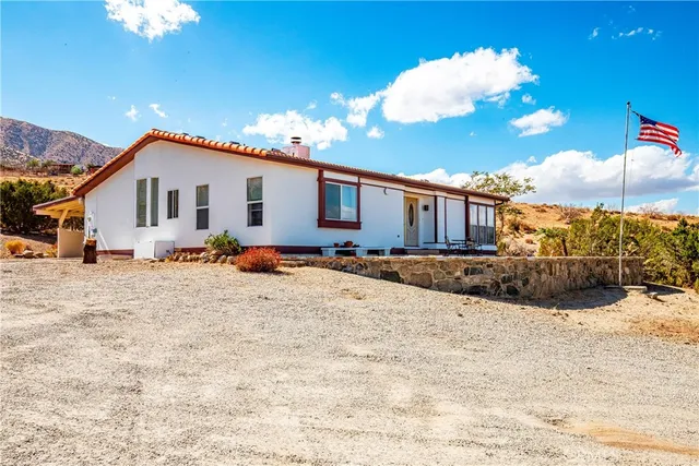 a view of a house with a yard covered in snow