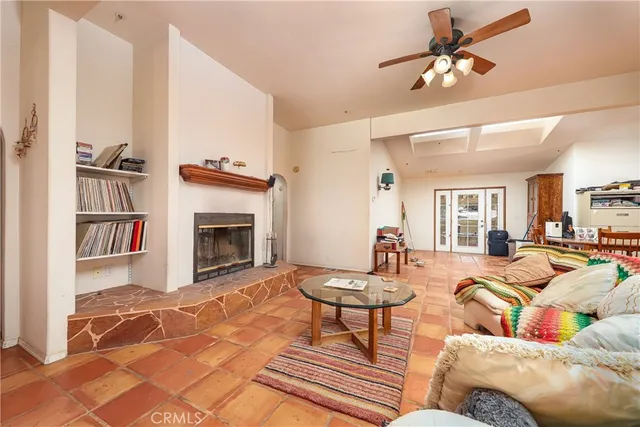 a living room with furniture a rug and a fireplace