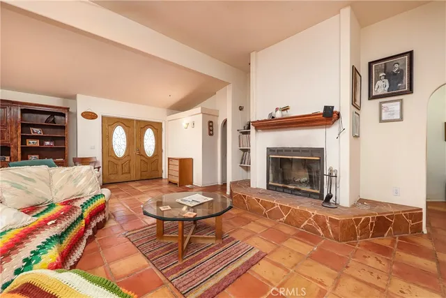 a living room with furniture a rug and a fireplace