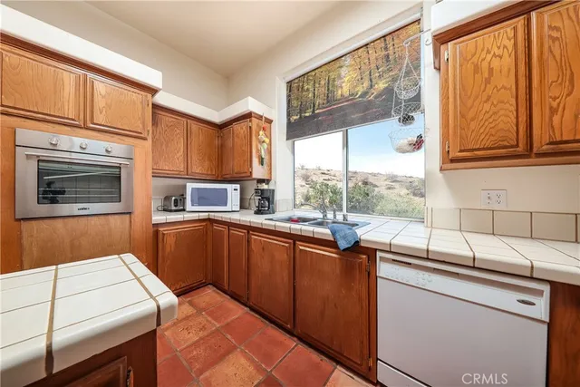 a kitchen with a sink and a stove top oven