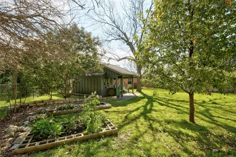 a backyard of of a house with a yard and outdoor seating