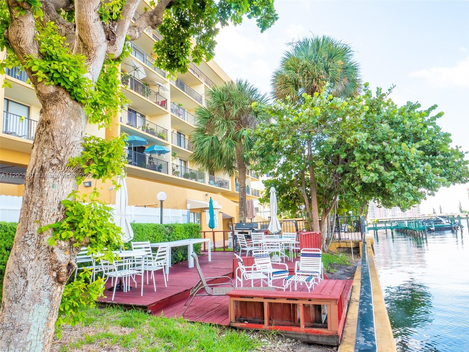 17878 North Bay Road, Unit 306 Sunny Isles Beach, FL 33160 - Photo 15 of 20 a view of a chairs and table in backyard of the house