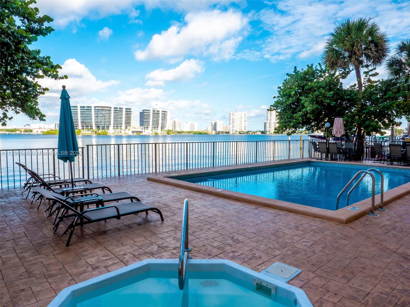 17878 North Bay Road, Unit 306 Sunny Isles Beach, FL 33160 - Photo 5 of 20 a view of a chairs and table in the back yard
