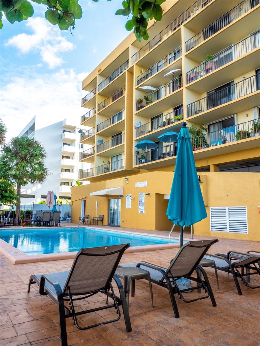 17878 North Bay Road, Unit 306 Sunny Isles Beach, FL 33160 - Photo 6 of 20 a couple of blue chairs sitting in front of a building