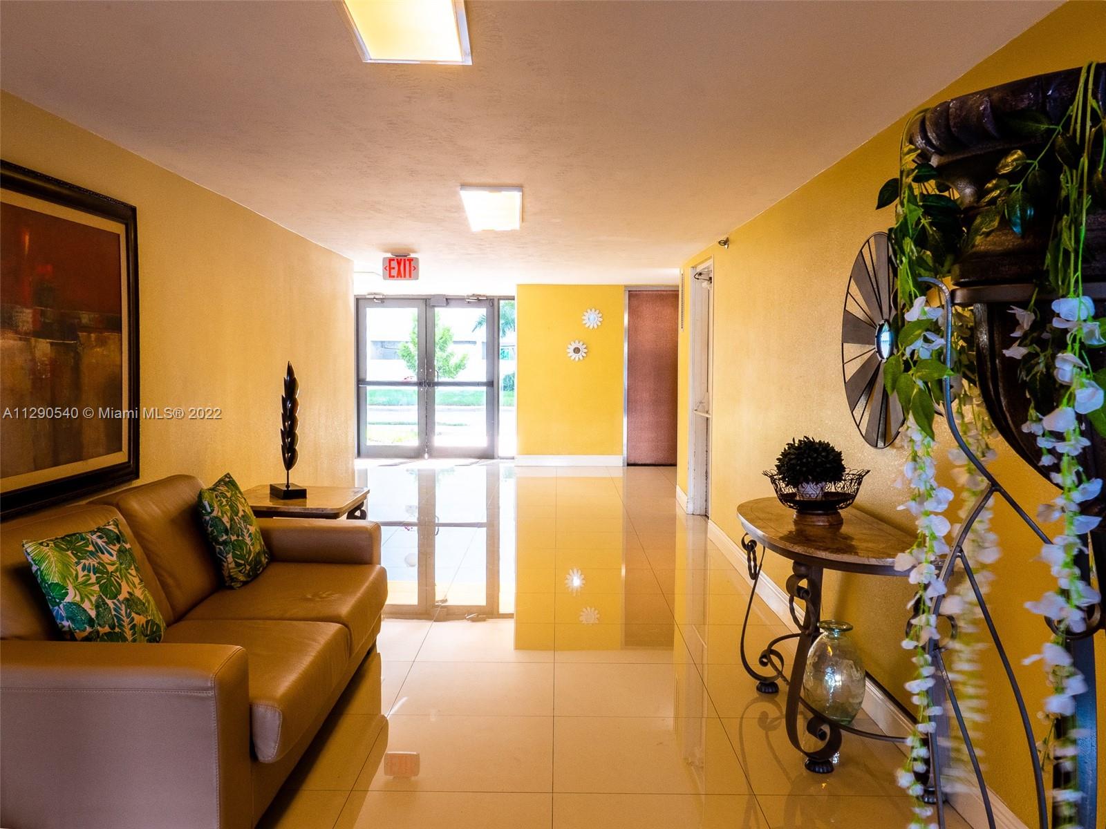 17878 North Bay Road, Unit 306 Sunny Isles Beach, FL 33160 - Photo 8 of 20 a living room with furniture and a floor to ceiling window