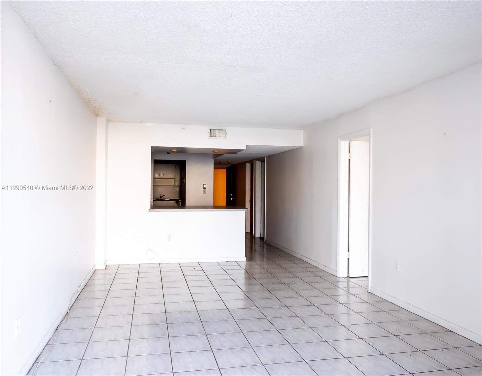 17878 North Bay Road, Unit 306 Sunny Isles Beach, FL 33160 - Photo 10 of 20 a view of a hallway with wooden floor and a fireplace