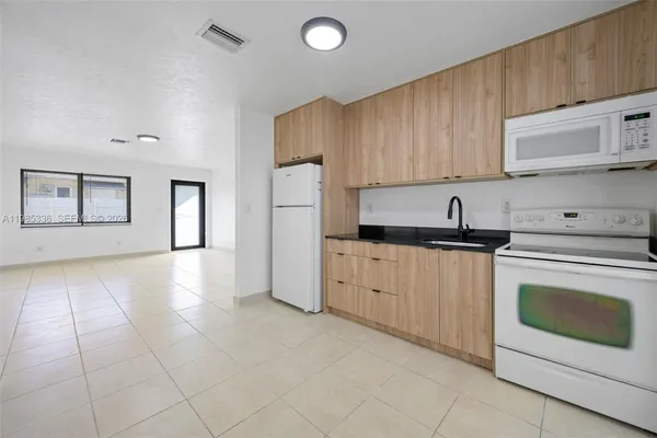 a kitchen with cabinets and white appliances