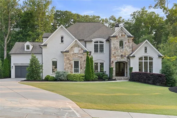 a front view of a house with a yard