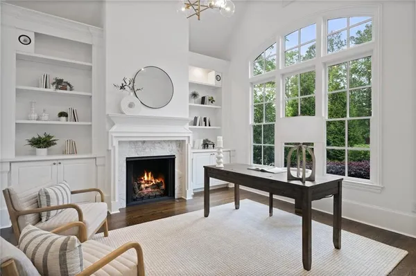 a view of a dining room with furniture large windows and wooden floor