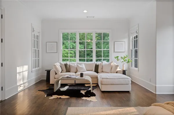 an empty room with wooden floor and ceiling fan